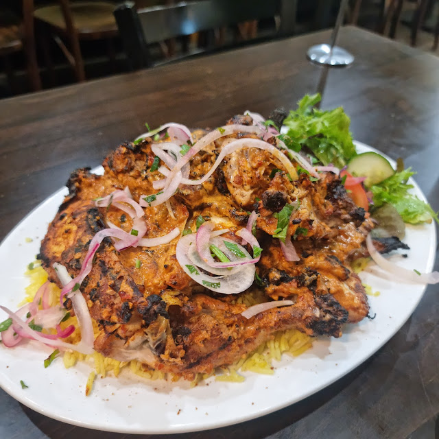 Charcoal chicken plate with rice, onion and salad at Gad's