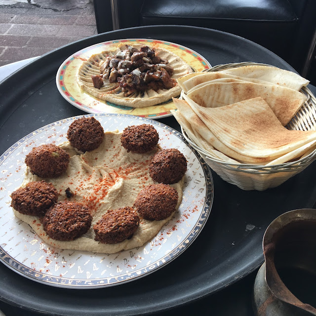 Falafel, bread, hummus and grilled meat on a Gad's table